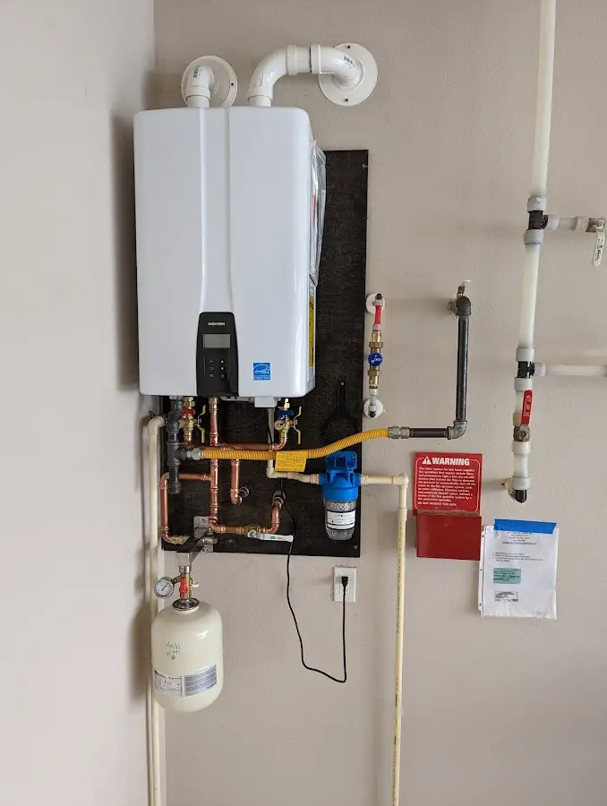 Professional plumber installing copper piping in a Copperopolis home